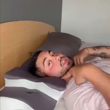 Hombre tumbado boca arriba con la cabeza apoyada en la almohada cervical